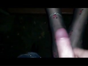 Chick in stockings gives a footjob in a public